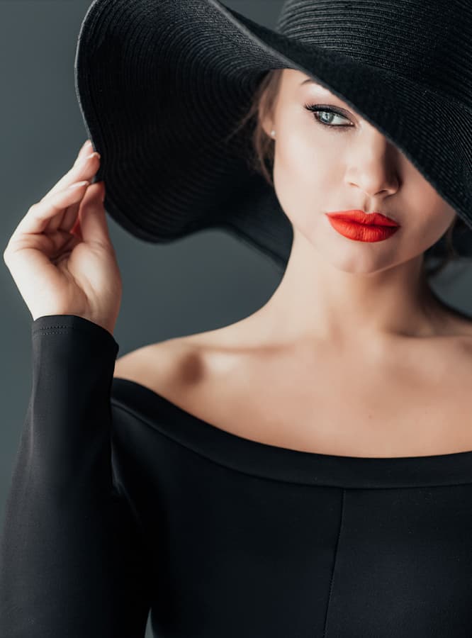 sun damage prevention and treatment patient model in a black hat and dress