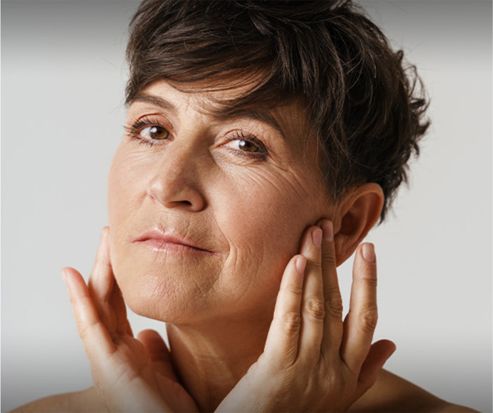 clinical trials model with short dark hair resting her chin on her hand