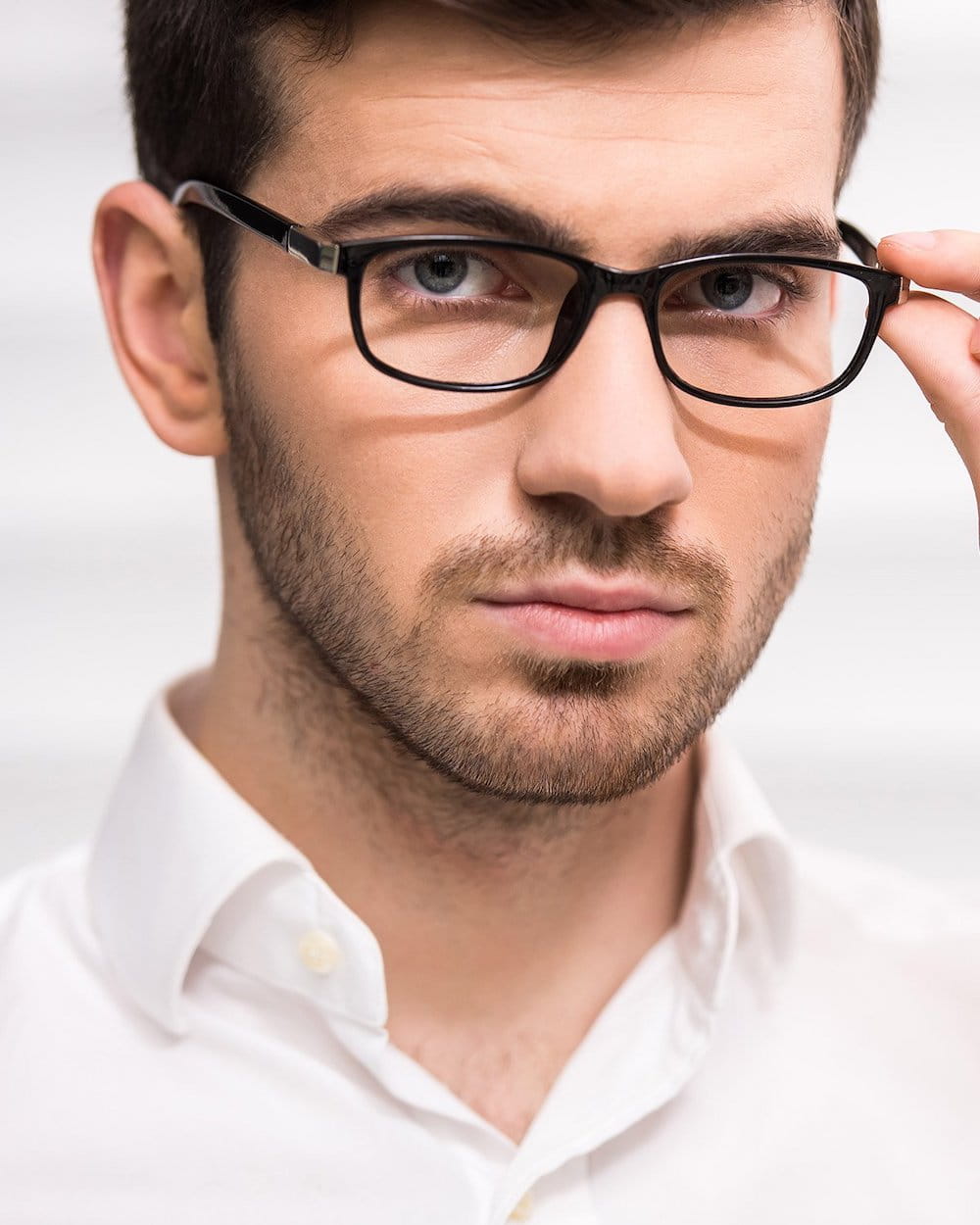 gethairmd patient model in a gray turtleneck running his fingers through his hair