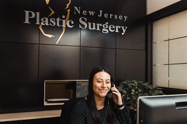 new jersey plastic surgery reception area with a staff member answering the phone