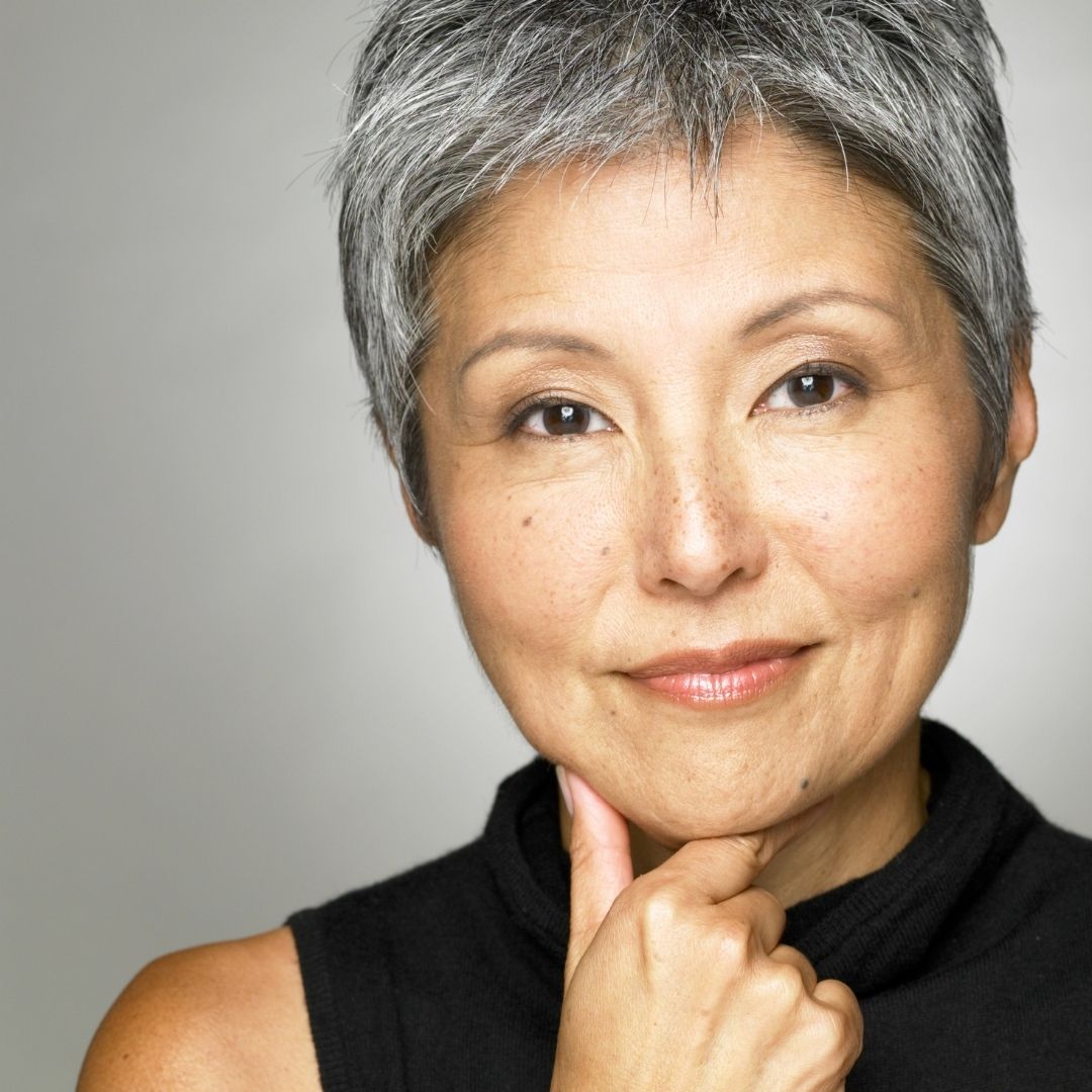 Non-surgical facelift patient model with short hair and her hand to her chin